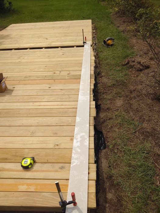 the back end of a wooden deck with tools on it