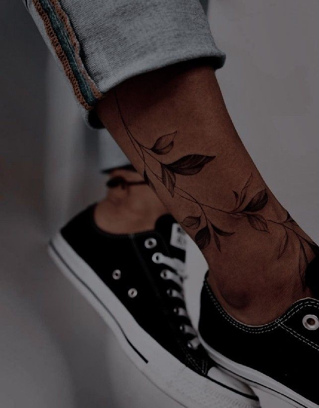 a person's foot with a tattoo on the lower part of their leg,