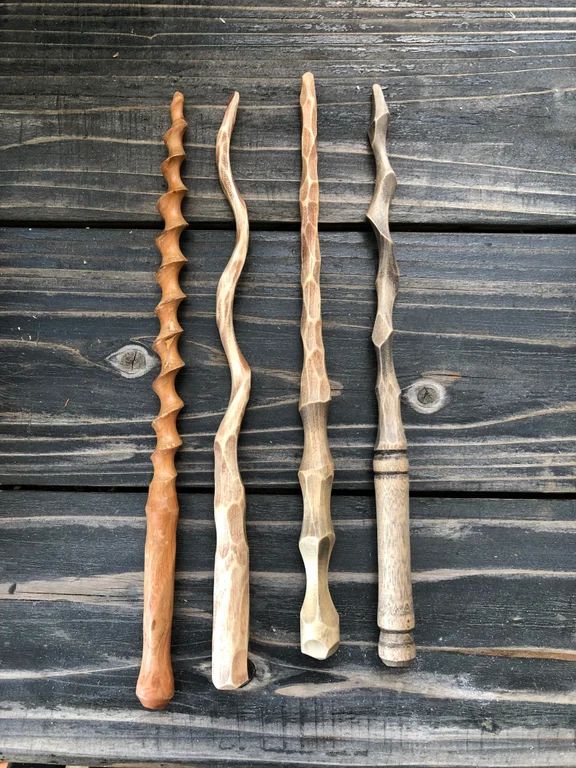 three different types of wood carving tools on a wooden surface