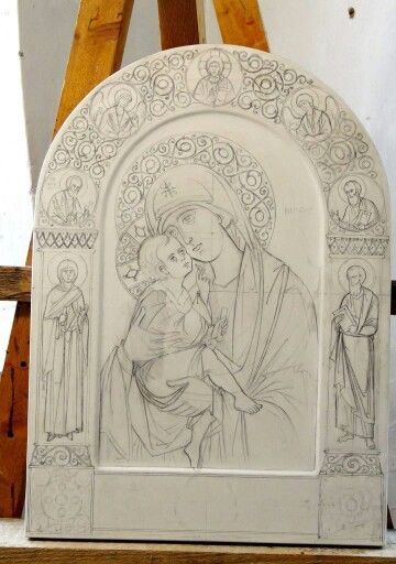 a drawing of the virgin mary and child jesus on a white marble block in front of an easel