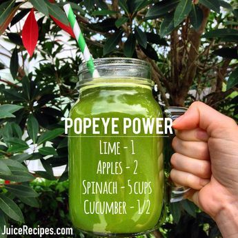 a person holding up a green drink with the words pope power on it in front of some trees