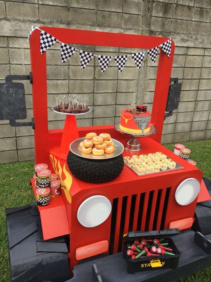 a red jeep birthday party with food and desserts