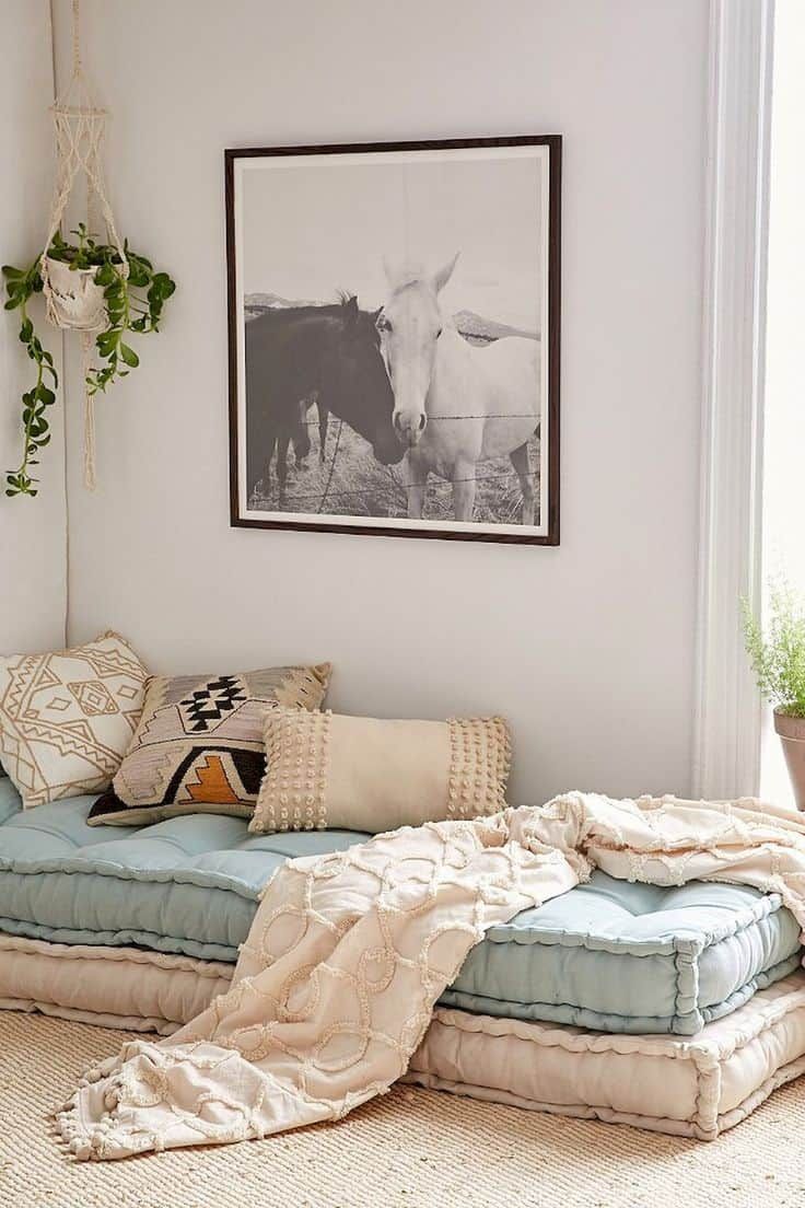 a living room filled with lots of pillows and blankets