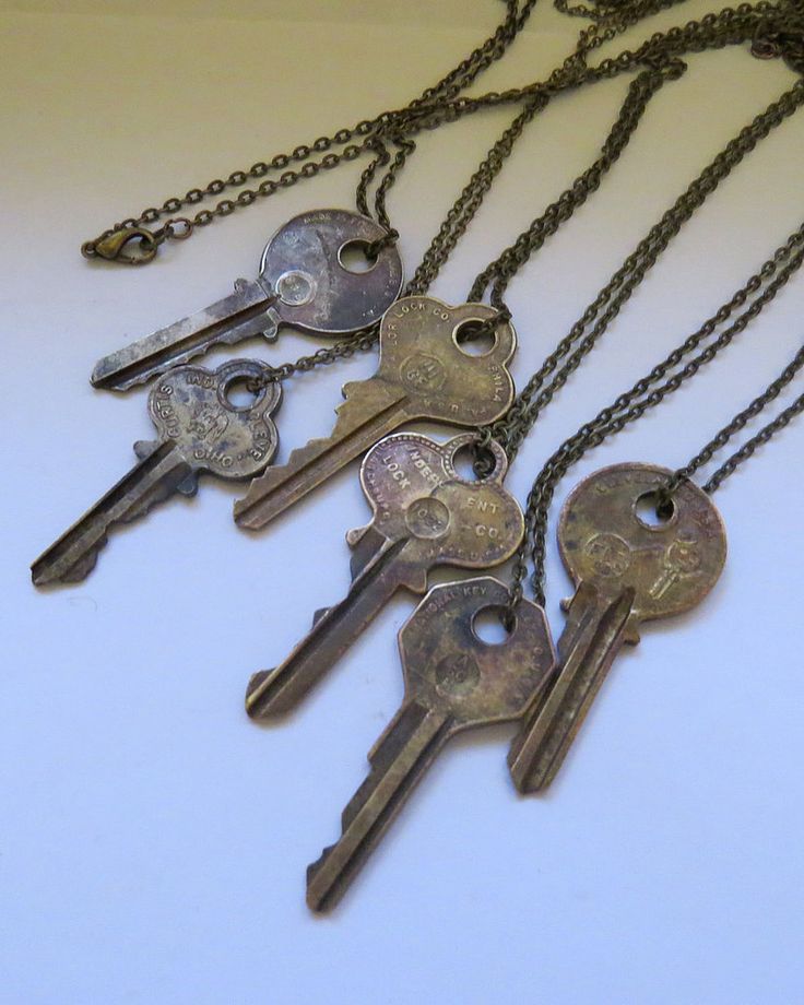 five antique keys are attached to a chain