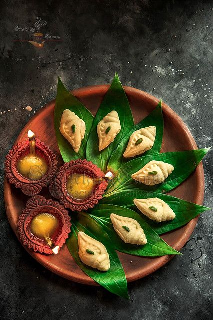 an overhead view of some food on a plate with leafy greens and sauces