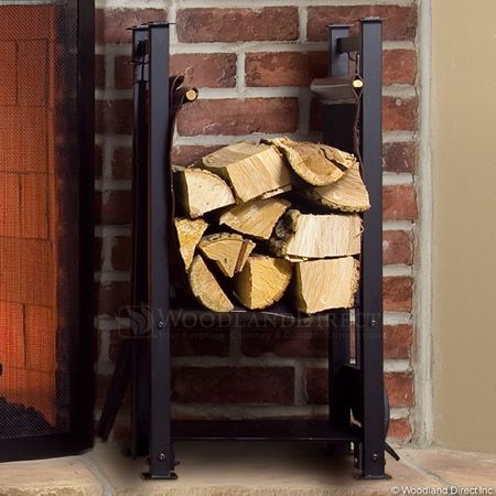 a fire place with logs in front of it and a fireplace screen on the wall