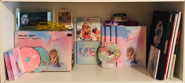 there are many dvds and cds on the bookcases in this room, including one for taylor swift