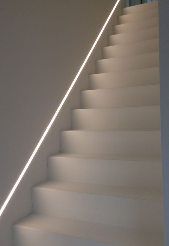 the stairs are white and there is a light on them