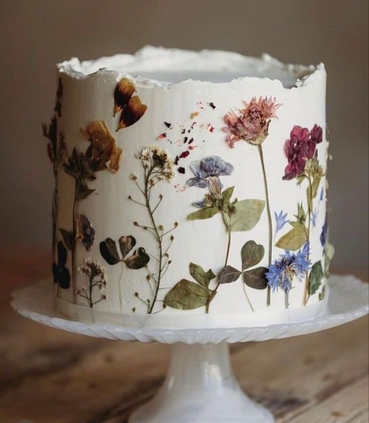 a white cake with flowers painted on it