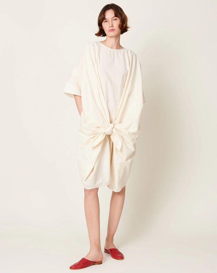 Bow Dress in Cream | Black Crane | Covet + Lou | Covet + Lou Cotton Midi Dress With Slip Pockets For Daywear, Cotton Midi Dress With Slip Pockets, Cotton Midi Dress With Pockets For Daywear, Spring Cotton Midi Dress With Slip Pockets, Oversized Cotton Midi Dress, Spring Oversized Cotton Midi Dress, Oversized Cotton Midi Dress For Spring, Spring Oversized Dresses With Side Pockets, Oversized Spring Dresses With Side Pockets