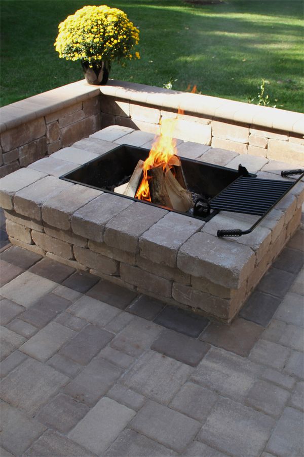 a fire pit sitting on top of a brick patio