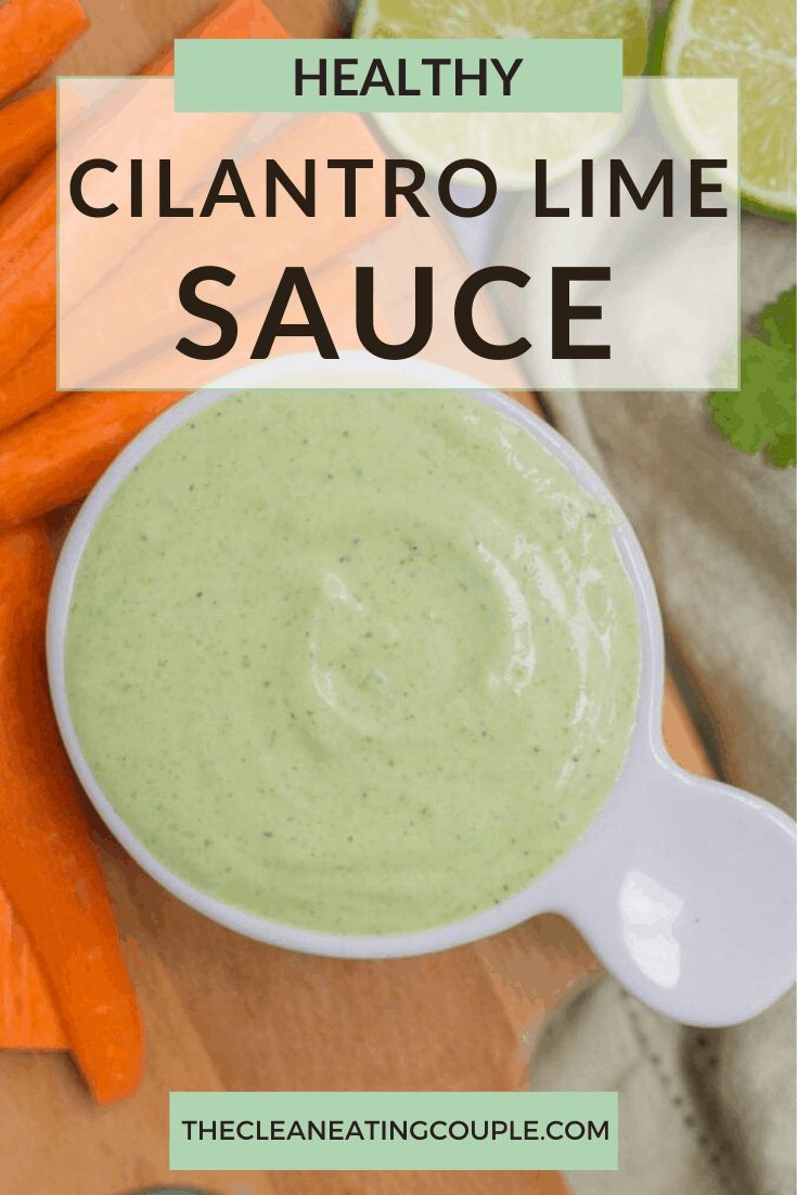 healthy cilantro lime sauce in a white bowl surrounded by carrots and celery