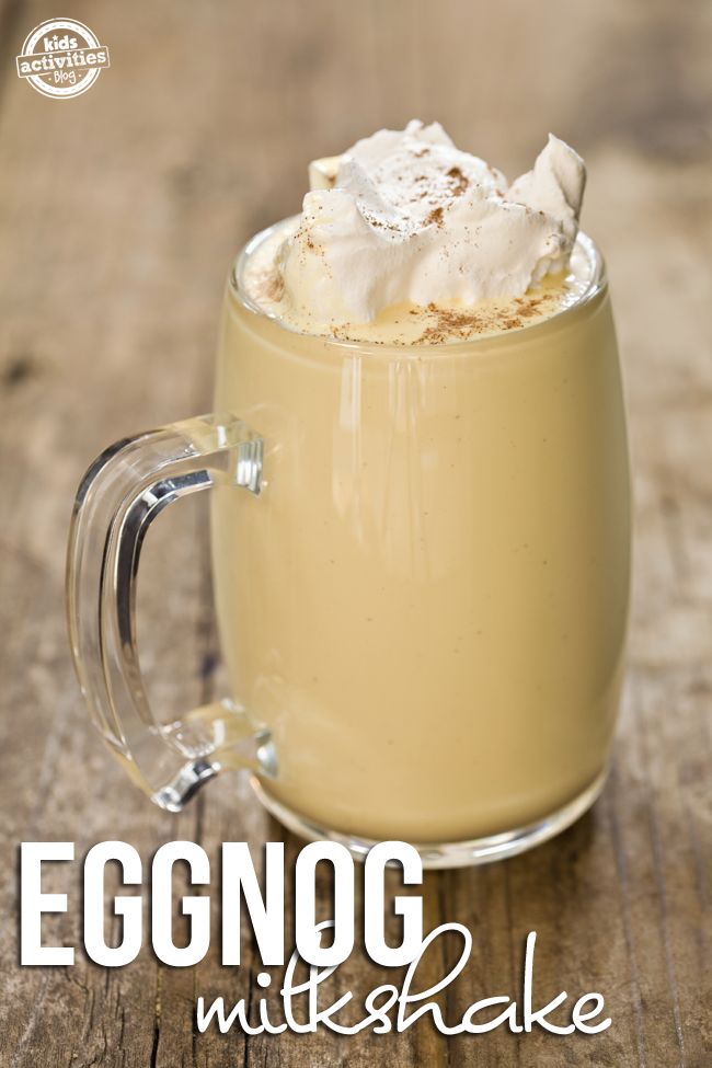 a glass mug filled with whipped cream on top of a table