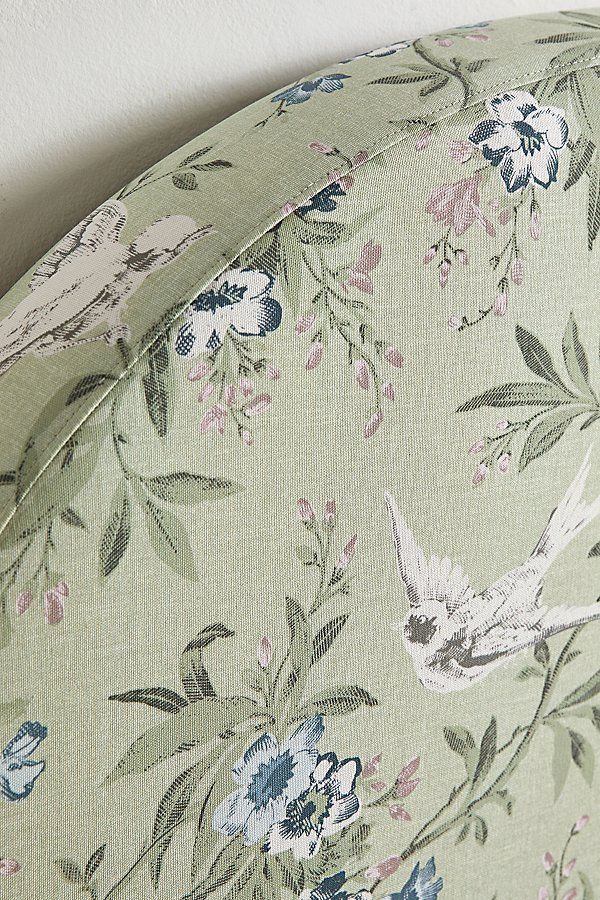 an upholstered headboard with flowers and birds on it