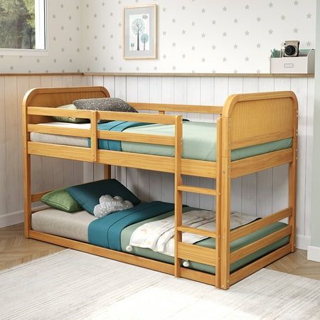 a wooden bunk bed with two sets of mattresses on top of it in a room