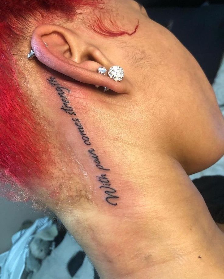 a woman with red hair has a tattoo on her neck