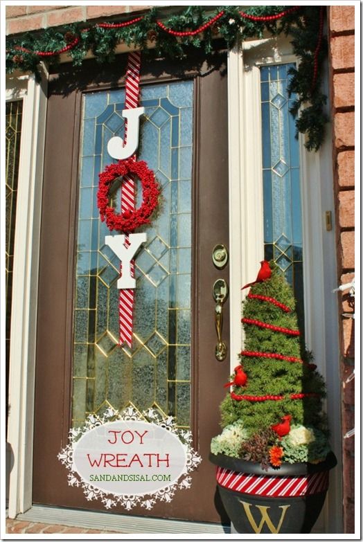 a christmas door decorated with wreaths and decorations