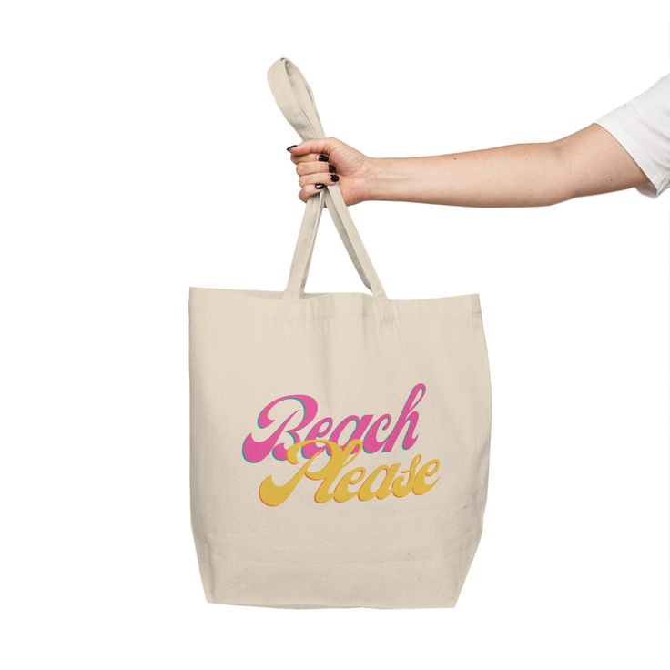 a person holding a tote bag with the words beach please on it and a spoon