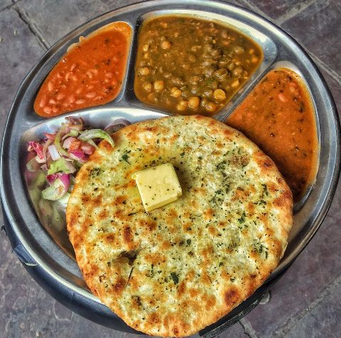 a plate with some food on it and sauces in the bowl next to it