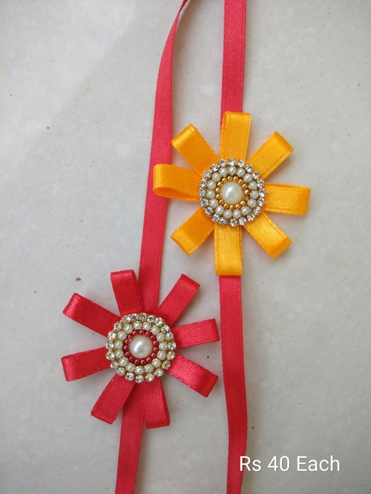 two red and yellow ribbons with pearls on them