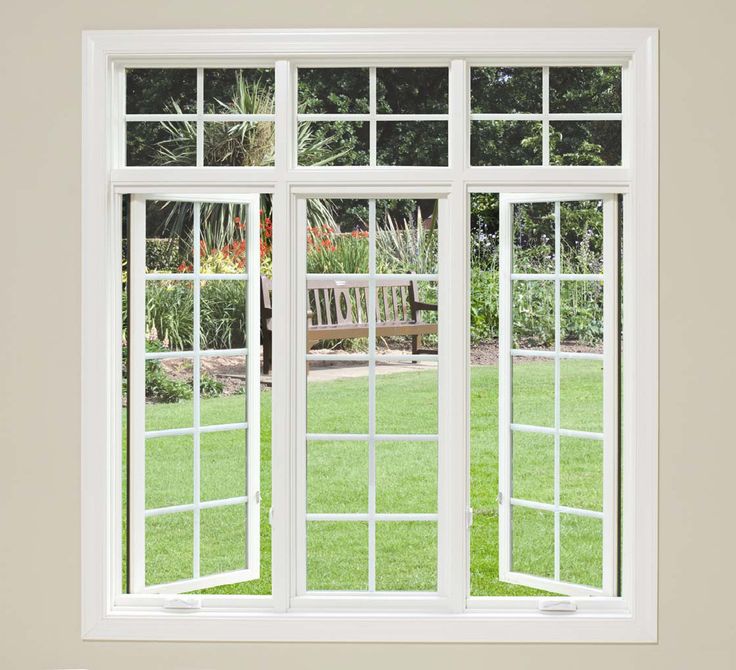 an open white window with green grass in front of it and a bench on the other side