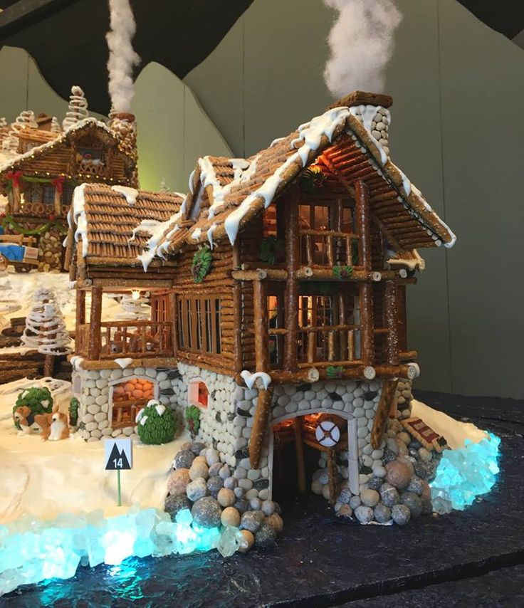 a gingerbread house made to look like it has snow on the roof