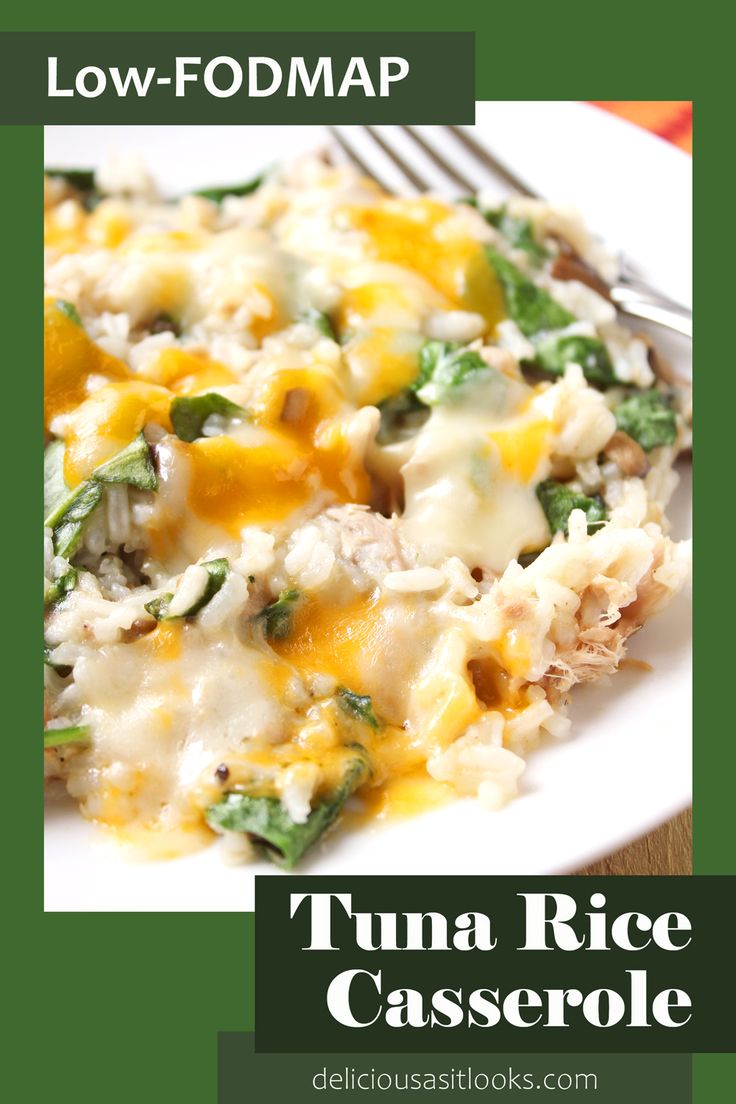 a white plate topped with rice covered in cheese and spinach