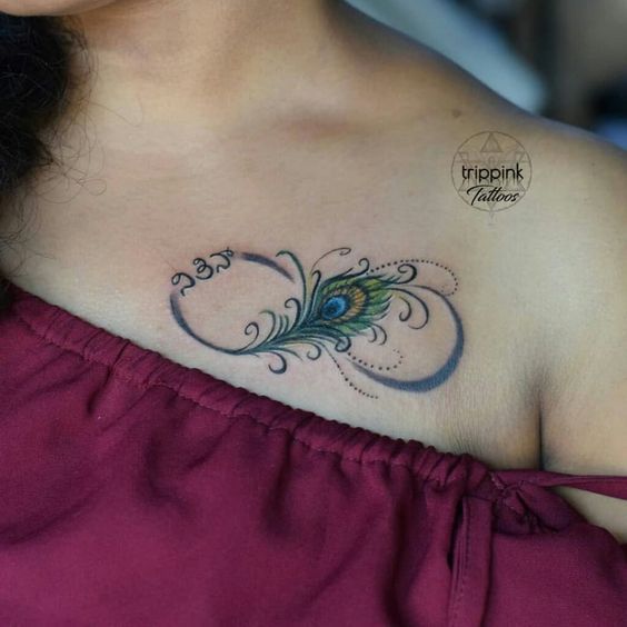 a woman with a peacock feather tattoo on her chest