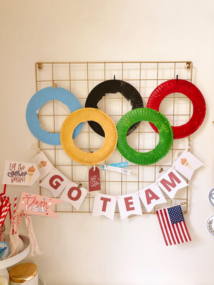 there is a sign that says go team and some paper wreaths hanging on the wall