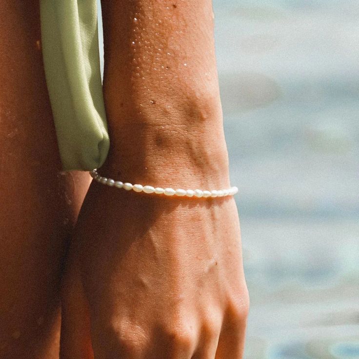 A true (summer) stunner, our Freshwater Pearl Bracelet gives you that warm fuzzy feeling of long summer days and fun in the sun. Each tiny pearl that's strung along this bracelet is different and unique, just like you! A precious piece of jewelry made from high quality stainless steel and coated in real 14K gold plated. We added a slightly longer extender so our Freshwater Pearl Bracelet fits all. Handcrafted with genuine mini freshwater pearls Adjustable length: 5.9” + 1.1” extender 925 Sterlin Minimalist Everyday Bracelets For Summer, Adjustable Minimalist Beaded Bracelets For Summer, Elegant White Pearl Bracelet For Summer, Elegant Summer Pearl Bracelet As Gift, Elegant Pearl Bracelet As Summer Gift, Elegant Summer Pearl Bracelet For Gift, Minimalist Adjustable Beaded Bracelets For Summer, Minimalist Summer Friendship Jewelry, Minimalist Summer Jewelry For Friendship