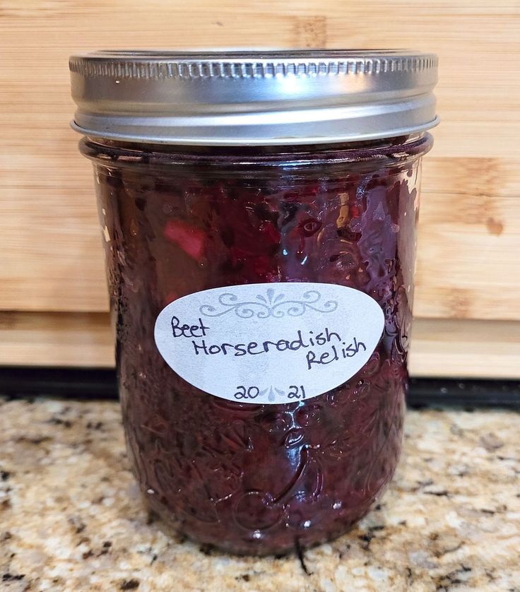 a jar filled with beets sitting on top of a counter