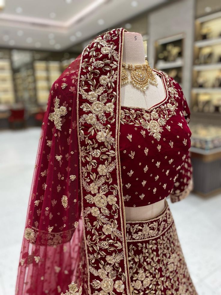 Elegant and luxurious, our Maroon Bridal Lehenga BL-147 is perfect for your special day. Made from soft velvet and adorned with intricate gold work, this lehenga exudes opulence and sophistication. Make a statement and feel like royalty with this stunning piece. Fabric: Velvet! WASH CARE INSTRUCTIONS - Please Dry clean only when it is applicable! Ready to Ship! Elegant Gold Velvet Lehenga, Festive Gold Velvet Lehenga, Gold Velvet Lehenga For Wedding, Elegant Velvet Choli With Traditional Drape, Gold Velvet Sets With Traditional Drape, Traditional Gold Velvet Drape Sets, Velvet Saree Set With Zari Work, Velvet Saree With Pallu For Wedding, Festive Velvet Lehenga