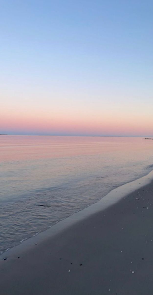 the beach is clean and empty at sunset time, with no people on it or in the water