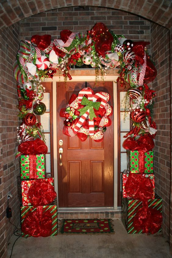 a door decorated with christmas presents and candy canes