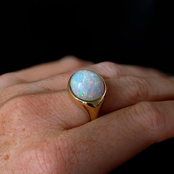 This beautiful ring features a 9.53 carat east west opal solitaire set in solid 14K gold. This Opal ring makes a beautiful October birthstone gift for your loved ones! This ring is made with solid 14K Gold and natural Earth mined SI / G-H diamonds. As listed, this ring is ready to ship. If you're interested in purchasing this setting with a different center stone please message us! Classic Oval Opal Ring With Polished Finish, Fine Jewelry Oval Opal Ring With Polished Finish, Oval Opal Ring With Polished Finish In Fine Jewelry, Oval Opal Ring With Polished Finish, Heirloom Oval Opal Ring With Polished Finish, Modern Round Opal Ring, Classic Opal Ring With Polished Oval Cabochon, Classic Opal Ring With Oval Cabochon And Polished Finish, Modern Oval Opal Ring