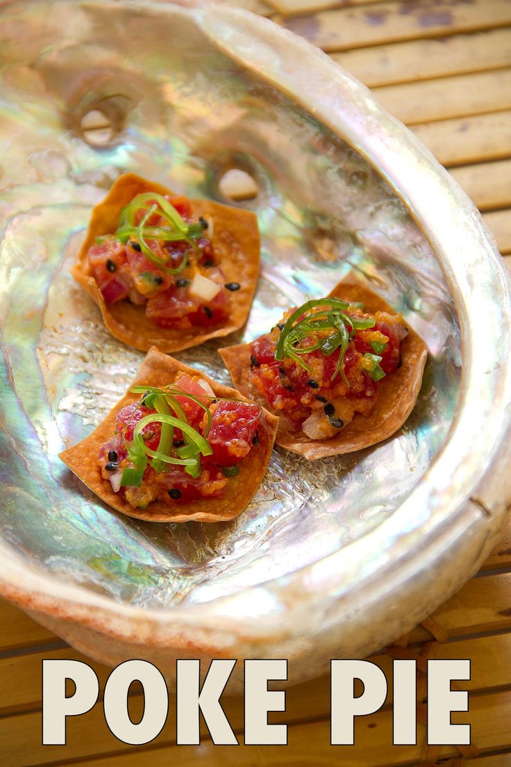 three small pieces of food sitting on top of a metal tray with the words poke pie