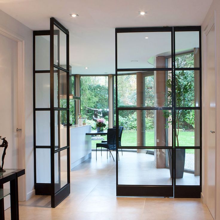 an open glass door leading to a dining room