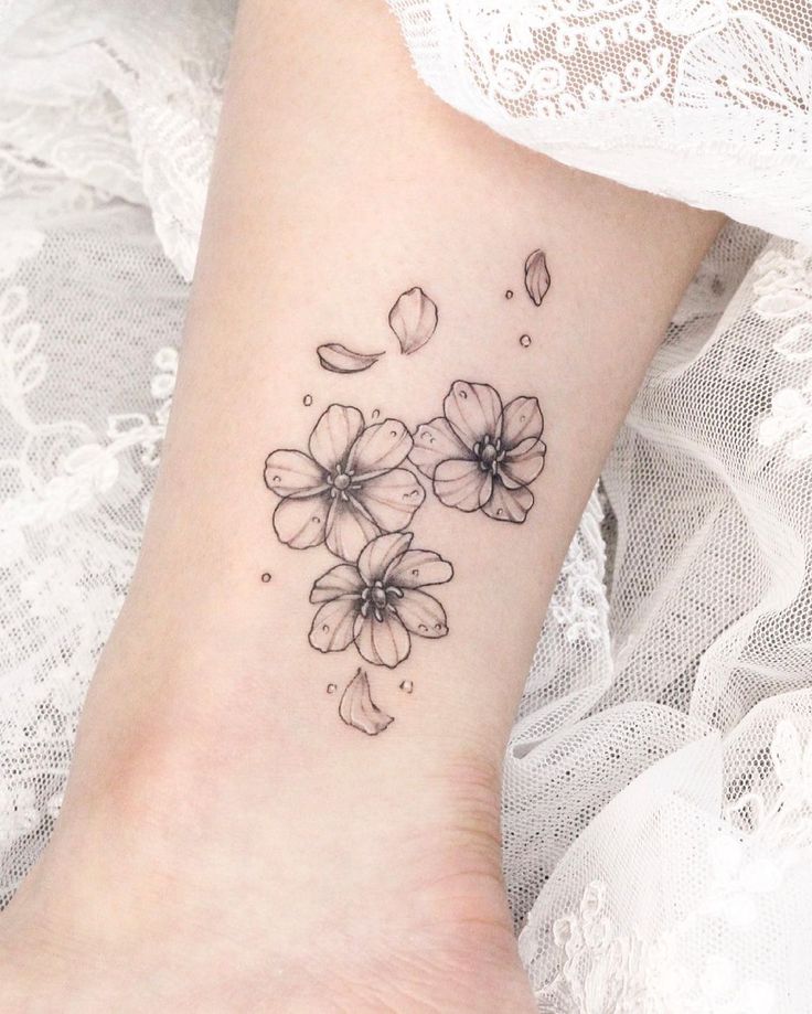 a woman's foot with flowers on it