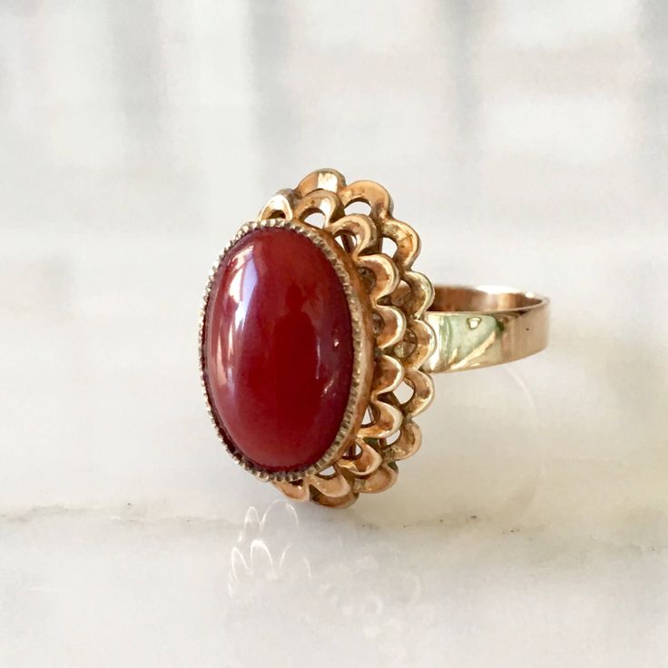 Details: Stunning vintage 14K gold Coral ring. It is a beautiful stone, and setting with lots of detail and life in it. The ring is in excellent condition with no visible flaws. Please ask all necessary questions prior to placing an order. Measurements: The size is 5 3/4 US and can be sized for a fee. The coral measures 13mm x 9mm, and has a depth of 2.2mm. Condition: The overall all condition of this ring is excellent. Victorian Red Oval Filigree Ring, Elegant Carnelian Yellow Gold Rings, Elegant Carnelian Ring In Yellow Gold, Elegant Yellow Gold Carnelian Ring, Elegant Carnelian Ring For Formal Occasions, Victorian Red Oval Cabochon Jewelry, Elegant Red Cabochon Ruby Ring, Heirloom Red Ruby Cabochon Ring, Elegant Carnelian Rings For Wedding