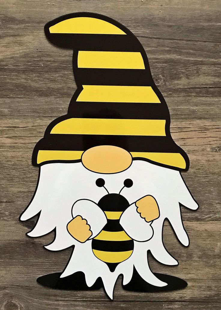 a paper cut out of a bee wearing a hat