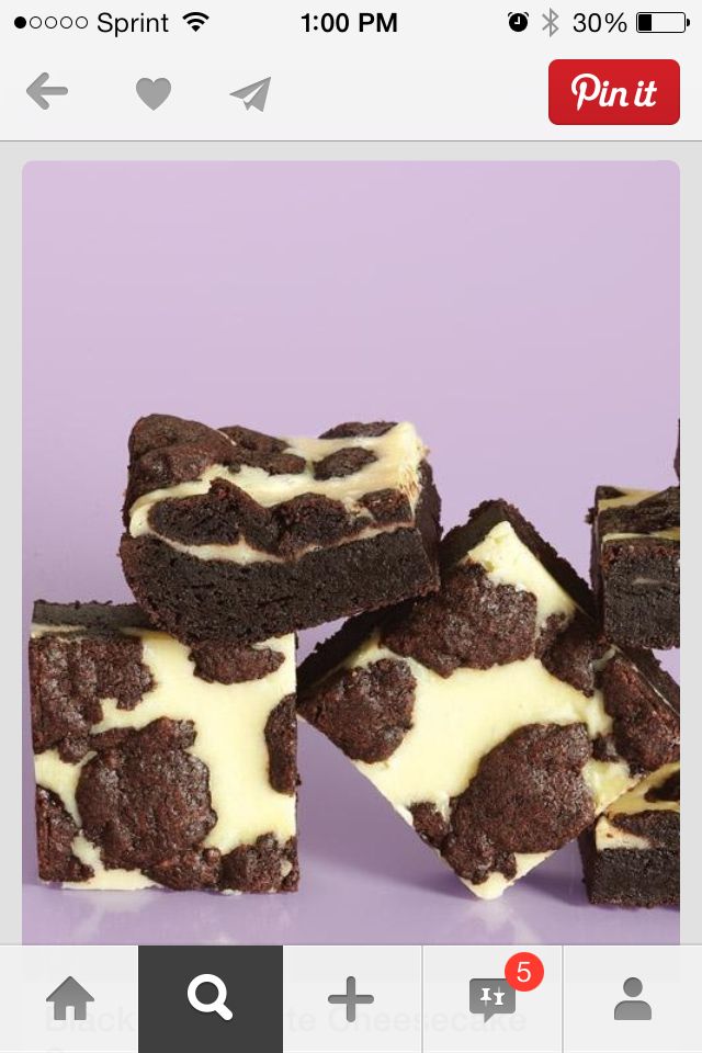 chocolate brownies with white frosting on purple background