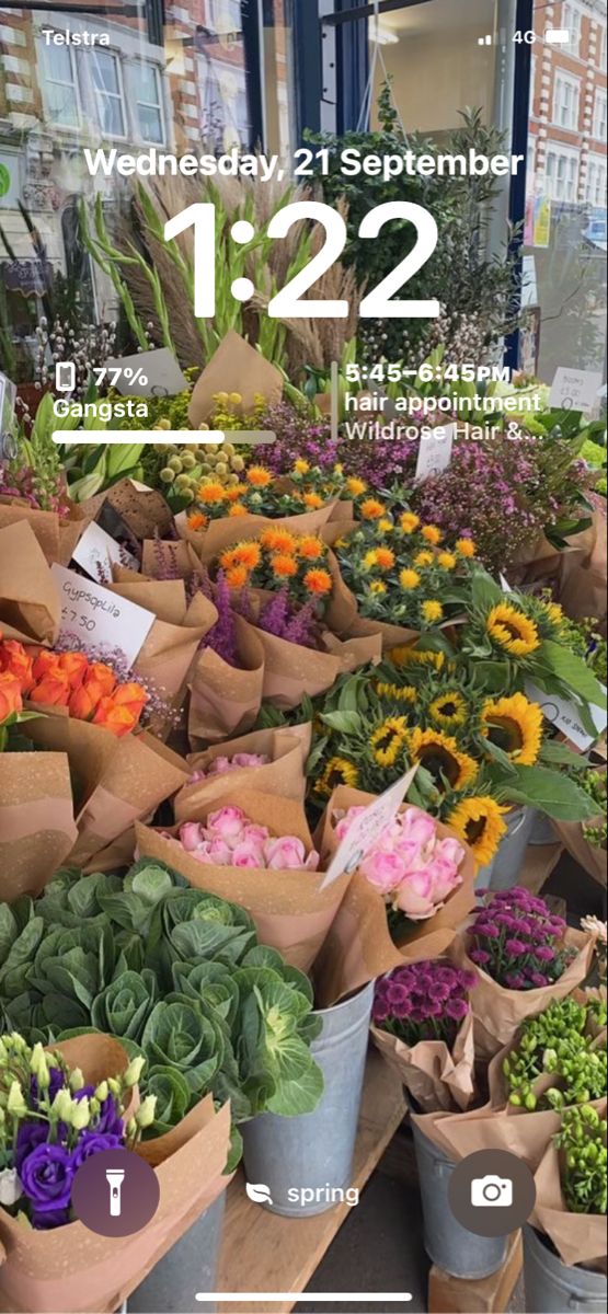 a bunch of flowers that are in buckets on a table with the numbers 12 - 22