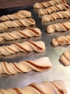 bread rolls are lined up on a baking sheet and ready to go into the oven