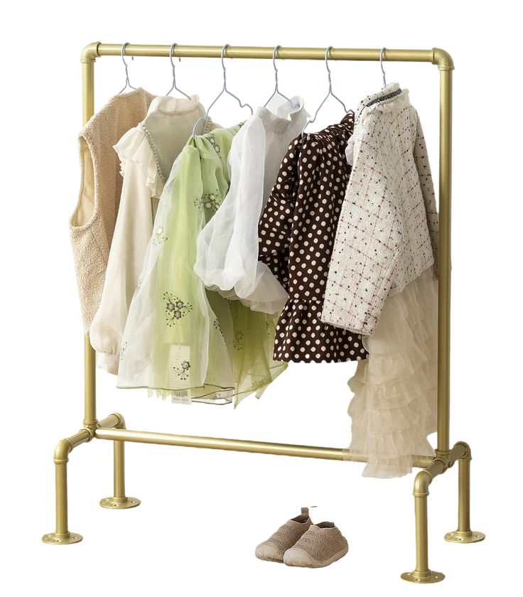 a rack with clothes and shoes hanging on it's sides next to a pair of slippers