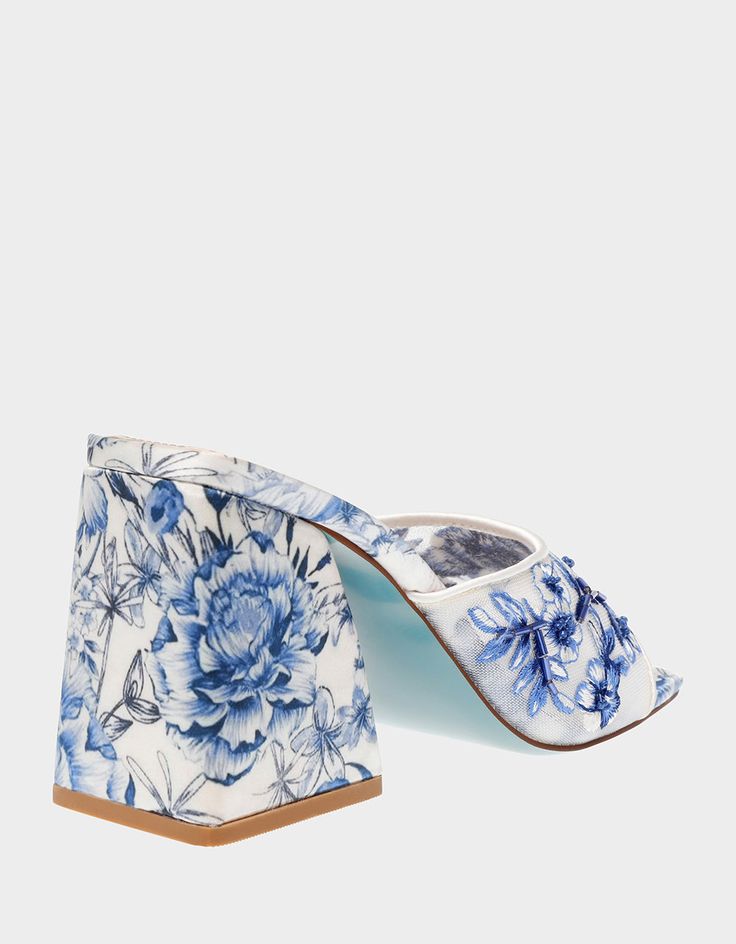 Transform from day to night with the ROO Blue Floral slip-on heel! This stunning sandal features a sturdy block heel and a breezy slip-on toe strap embellished with vibrant blue floral patterns, making it the perfect match for dresses or denim. Mesh textile upper material with beaded embellishments Synthetic lining/sock Synthetic Betsey Blue sole 3.75 inch heel height Imported Funky Heels, Beaded Embellishments, Unique Heels, Lavender Brown, Cami Nyc, Tony Bianco, Floral Shoes, Solid & Striped, Women's Heels