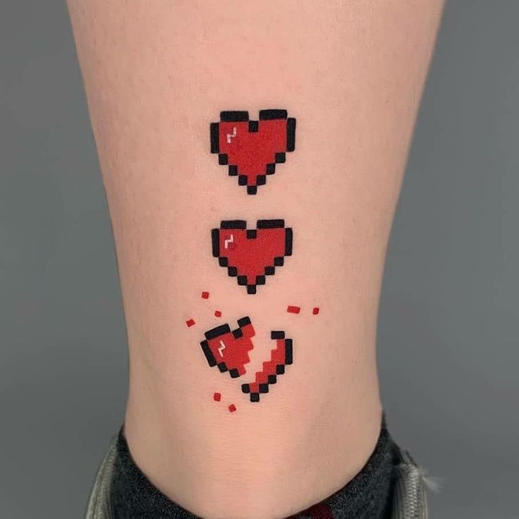 a woman's lower leg with pixel heart tattoos on her left side ribcage