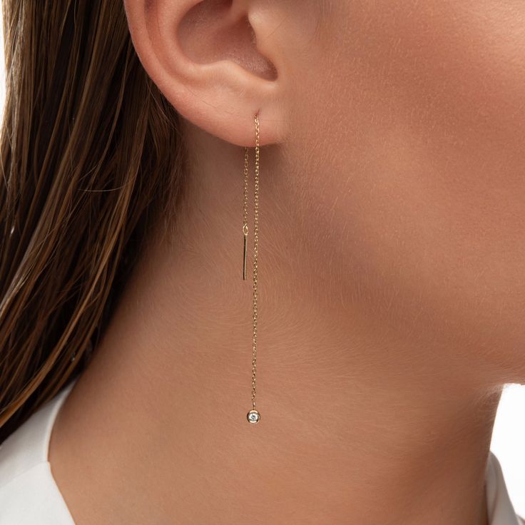 Diamond Threader Earrings Elevate your style with our 14K Gold Threader Earring, featuring a brilliant 2.00mm 0.06ct diamond in a sleek bezel setting. ✨ ✨ Crafted from 100% 14K Solid Gold ✨ Dazzling 2.00mm/0.06ct F-G SI1+ Diamond ✨ 10cm chain with a 1.00mm thickness 🌟 Threader Earring FAQs: Q: Are threader earrings comfortable to wear? A: Absolutely! Our threader earrings are designed for comfort and can be easily adjusted to your preferred length. Q: How do I put on threader earrings? A: Simply thread the chain through your piercing, and gently pull to the desired length. It's a breeze! Q: Are threader earrings secure? A: Yes, our threader earrings are designed with a secure fit, ensuring they stay in place while you shine. Q: Are these earrings suitable for all occasions? A: Absolutely! Fine Jewelry Drop Earrings With Adjustable Chain, Gold Long Drop Jewelry For Anniversary, Dainty Linear Earrings For Anniversary, Gold Dangle Threader Earrings For Anniversary, 14k White Gold Linear Earrings For Pierced Ears, Classic Yellow Gold Earrings With Adjustable Chain, Minimalist Long Drop Jewelry For Anniversary, White Gold Linear Earrings In 14k Gold, White Gold Linear Earrings, 14k