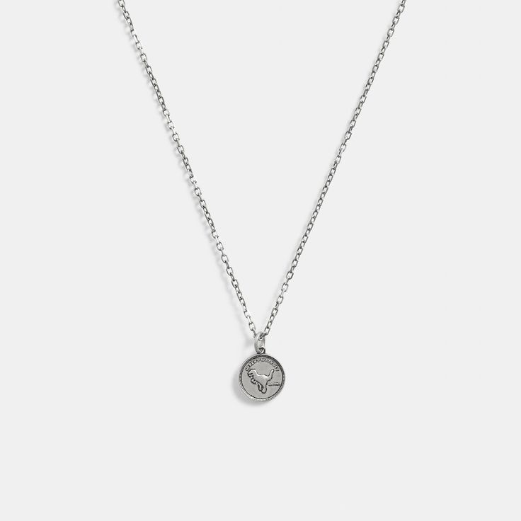 Part of our Men’s Jewelry Collection this long sterling silver chain necklace features a coin pedant detailed with Coach mascot Rexy. It’s finished with an easy clasp closure. | Coach Sterling Silver Coin Pendant Necklace Sterling Silver Medallion Coin Necklace With Chain, Classic Silver Necklace With Coin Pendant, Classic Silver Medallion Pendant Necklace, Classic Silver Pendant Medallion Necklace, White Gold Necklace With Coin Pendant, Sterling Silver Coin Necklace In White Gold, White Gold Sterling Silver Coin Pendant Necklace, Classic Silver Coin Pendant Necklace, Classic Silver Pendant Coin Necklace