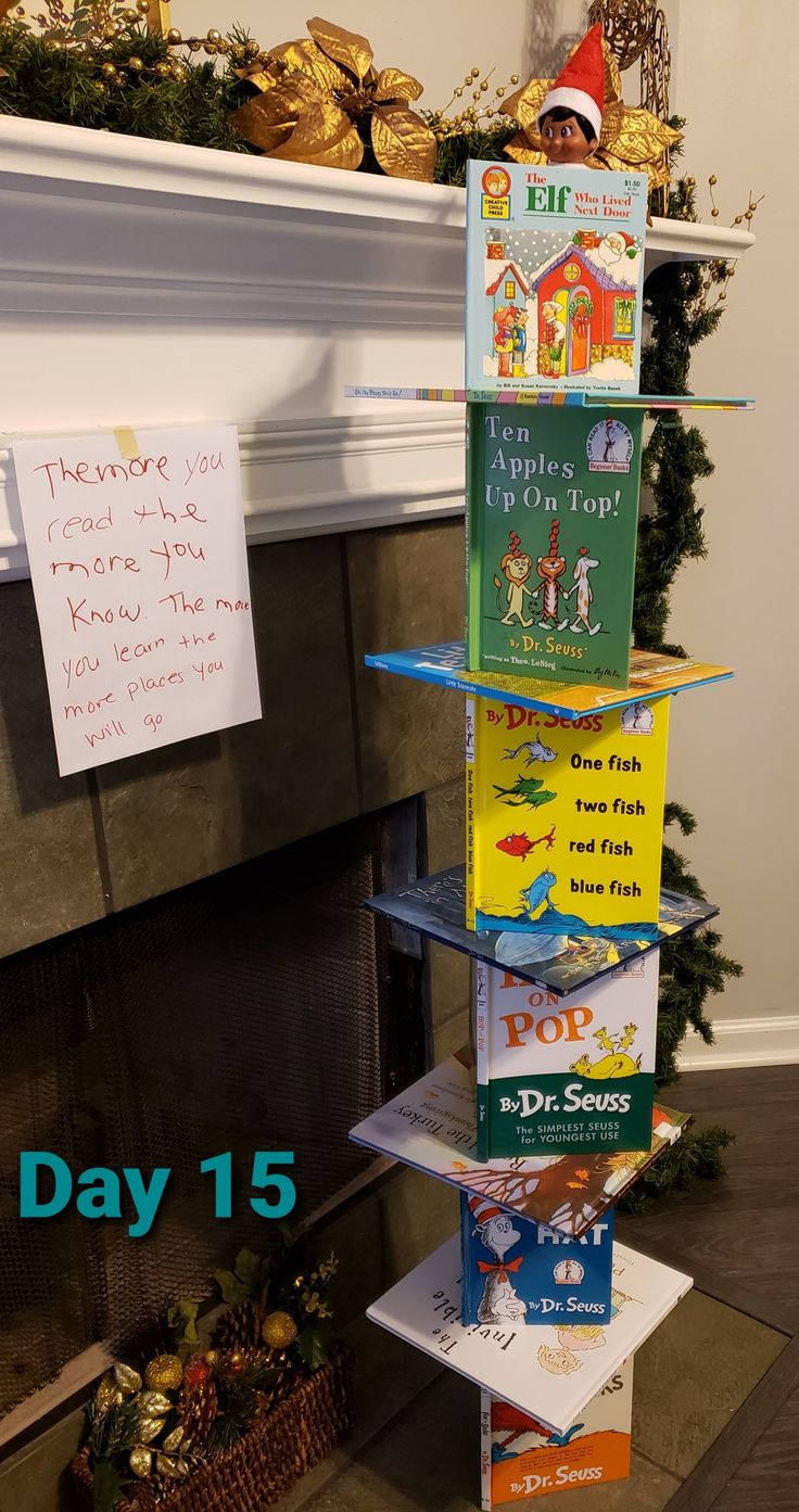 a stack of books sitting next to a fire place