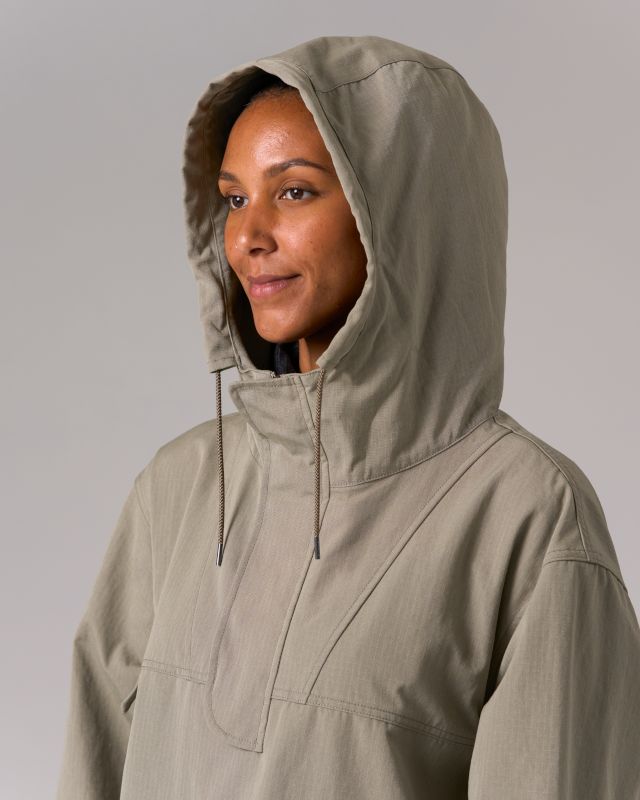 The Takibi Ripstop Anorak is a durable, fire-resistant hooded jacket. The anorak features two large flap pockets on the front, drawcords at the hood and hem, a covered half zipper on the front, and a zipper on the left side for easy on and off. Additional features include hand warmer pockets, an accessory loop on the right breast, ventilated panels on the back, and elastic cuffs. The material is an aramid-cotton blend with ripstop stitching throughout for fire resistance and durability. Hooded Utility Outerwear With Functional Drawstring, Hooded Raincoat With Drawstring Hood For Outdoor Activities, Utility Nylon Outerwear With Functional Drawstring, Outdoor Work Windbreaker With Detachable Hood, Utility Outerwear With Functional Drawstring For Fall, Hooded Windbreaker With Double-lined Hood For Hiking, Hooded Outerwear With Functional Drawstring For Streetwear, Utility Nylon Hooded Jacket With Double-lined Hood, Fall Utility Jacket With Detachable Hood For Hiking